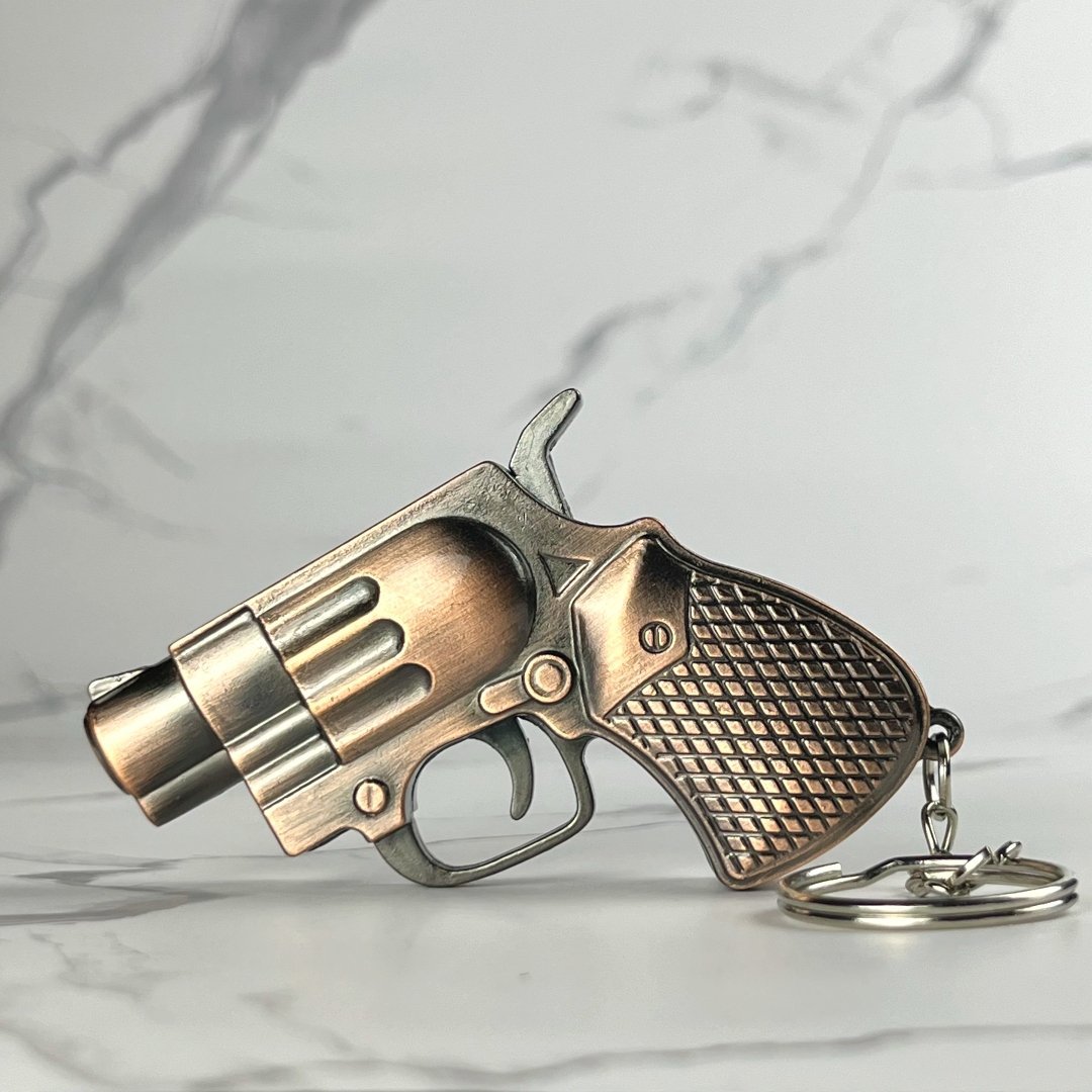 Bronze Mini Revolver Torch Lighter – refillable butane gun-shaped lighter with antique bronze finish, diamond-patterned grip, and keychain attachment
