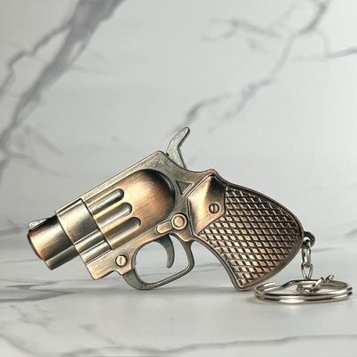 Bronze Mini Revolver Torch Lighter – refillable butane gun-shaped lighter with antique bronze finish, diamond-patterned grip, and keychain attachment