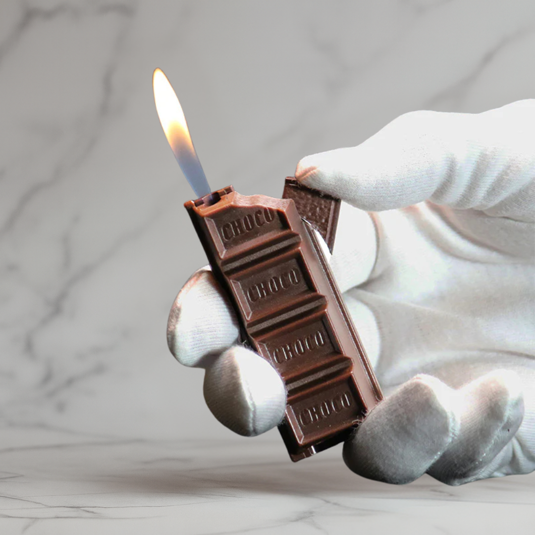 Hand holding a realistic chocolate bar lighter with a soft flame, designed to look like a chocolate bar on a marble background.
