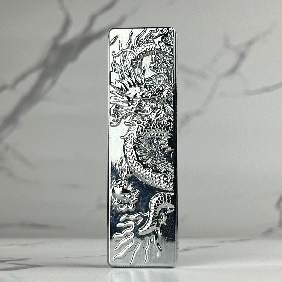 Engraved Dragon Lighter – sleek silver refillable butane metal lighter with intricate dragon engraving and reflective chrome finish