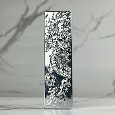 Engraved Dragon Lighter – sleek silver refillable butane metal lighter with intricate dragon engraving and reflective chrome finish