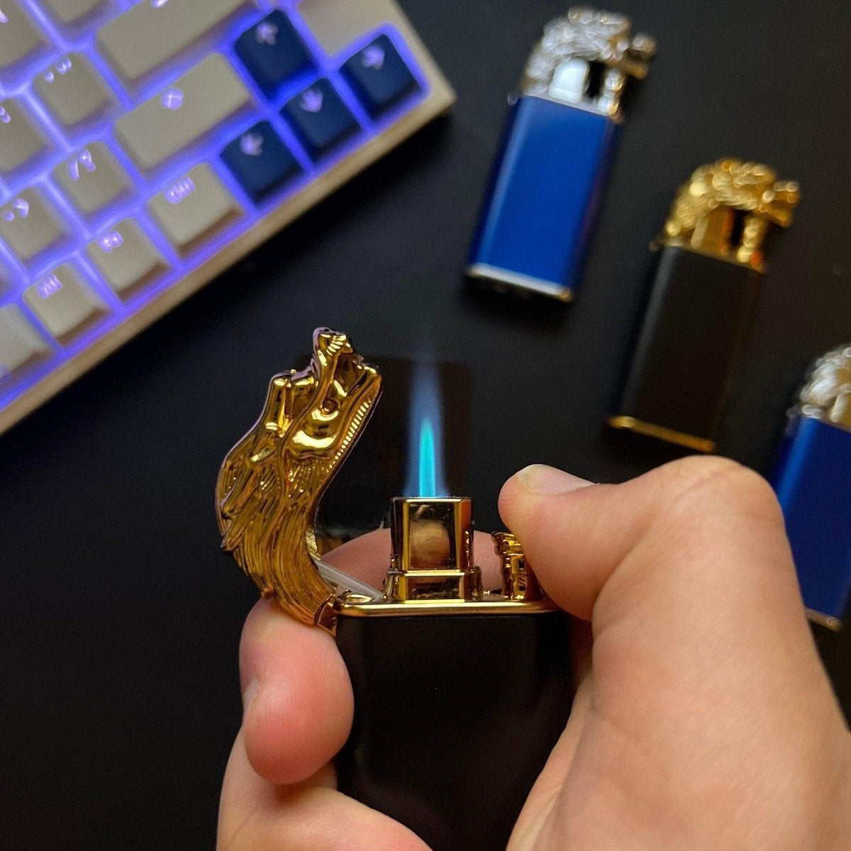 Gold Dragon Beast Flame Lighter – refillable butane torch lighter being lit by hand on a desk with other Beast Flame models in the background